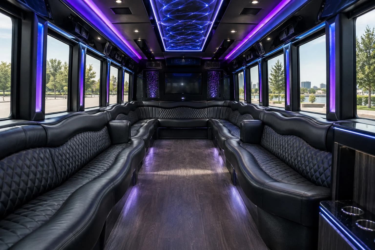 Party bus interior with wraparound seating and purple LED lighting