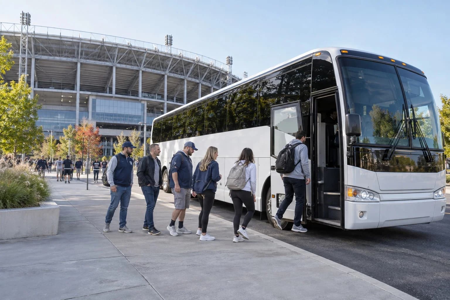Sports fans boarding a motorcoach outside a stadium